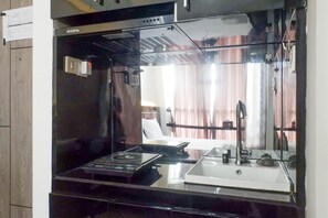 Room | Private kitchen | Fridge, stovetop, cookware/dishes/utensils - Best View Studio Apartment at Taman Melati (Surabaya)