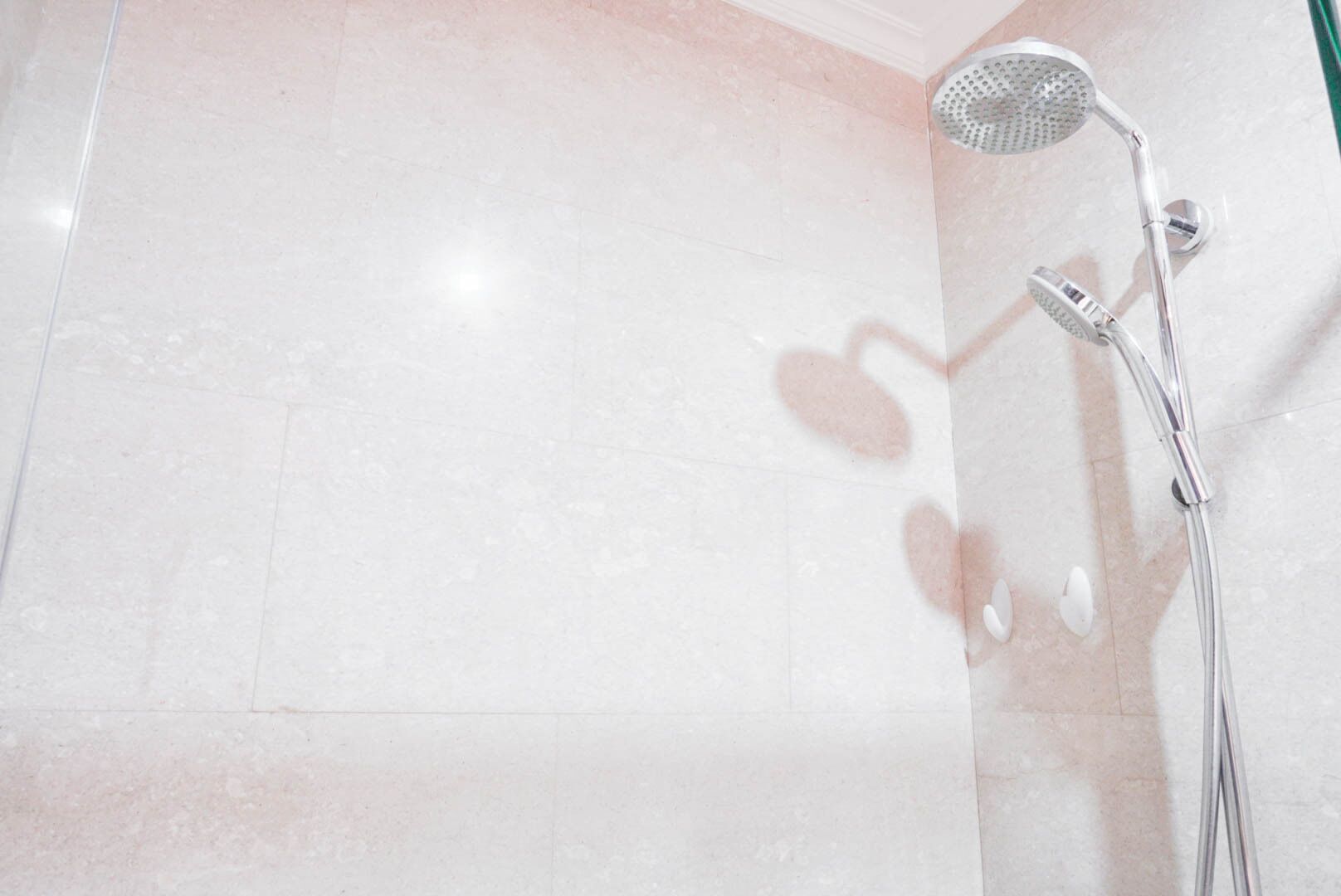 A bathroom with a shower and a toilet.