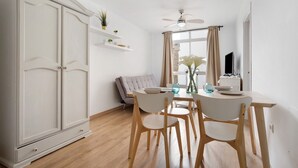 A dining area with a table, chairs, a ceiling fan, and a sofa. - Vacation Apartment "Playa Morro Jable 1c" near the Beach with Wi-Fi (Morro Jable)