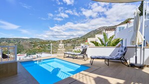 A rooftop pool with lounge chairs, a statue, and a view of the hills. - Cottage "Casa Loli" with Mountain View, Private Pool & Terrace (Frigiliana)