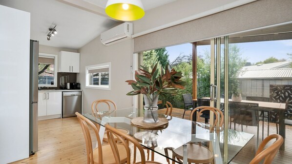 A modern kitchen with white cabinets, a built-in oven, and a coffee machine. - Goyarra in Rye - Located in the heart of Rye and a short walk to Peninsula Pantry Café. (Rye)