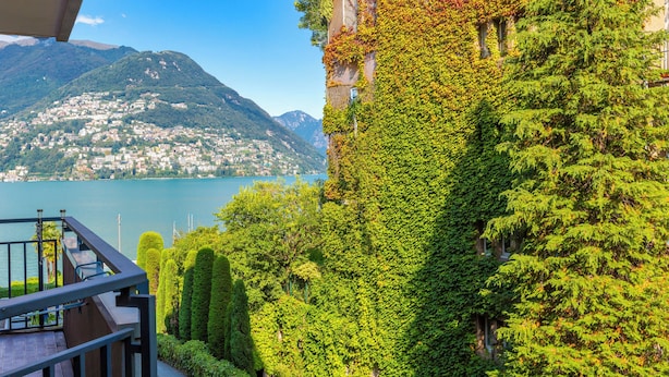 A balcony with a view of a lake and mountains. - Coloratura Frontlake Lugano With Terrace (Paradiso)