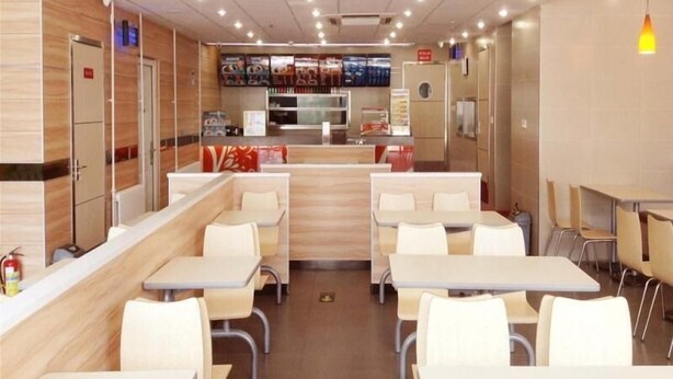 A modern restaurant interior with booths and tables, a counter, and a menu display. - Greentree Inn Beijing Tongzhou Tuqiao Subway Station Express Hotel (Tongzhou)