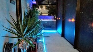 A narrow hallway with a potted plant and a small bench. - Welcome to your own private resort-style living (Marco Island)