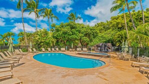 A swimming pool with lounge chairs and palm trees. - 1Br 1Ba Kahala Tropical Dream, Pool, Garden View 513 (Koloa)
