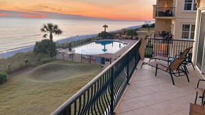 A balcony with a view of the ocean and a swimming pool. - Adagio A-205 - Amazing UPDATED Gulf Front Corner Unit! (Santa Rosa Beach)