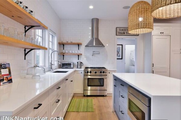 Enjoy cooking in this well-equipped kitchen with stainless steel appliances and ample counter space.