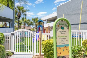 A playground sign with 'Welcome Loggerhead Beach' and 'Playground Rules' including 'Adult Supervision Required' and 'No Pets'. - Beachfront Escape to Unwind & Take in the Ocean Air (Myrtle Beach)