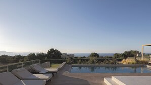 A rooftop pool area with lounge chairs and a view of the sea. - Impeccable design, total privacy & heated pool with sea views (Rethymno)