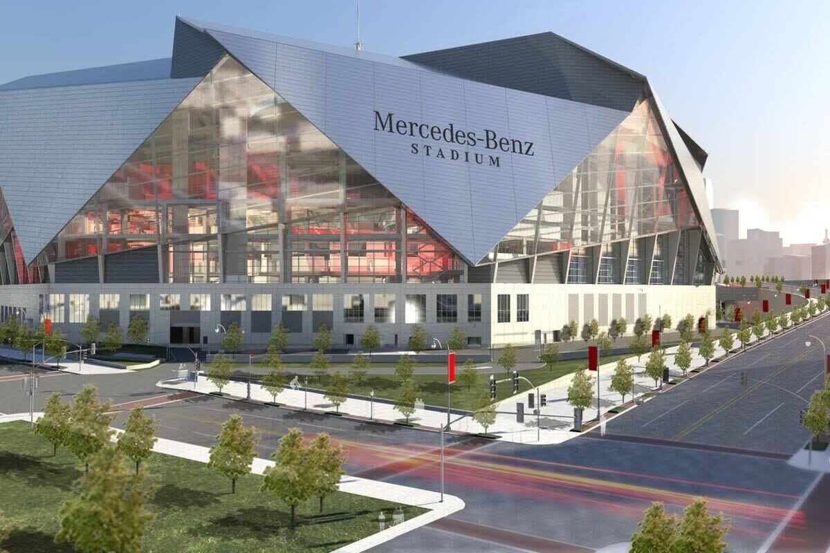 A modern stadium with a prominent Mercedes-Benz sign.