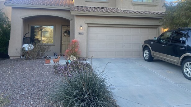 A two-story house with a garage, a driveway, and a black SUV parked in front. - Quit friendly Neighborhood  (Anthem)