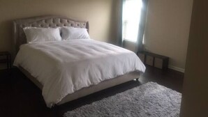 A bedroom with a large bed, a ceiling fan, and a window with curtains. - ❤️GREAT FOR FAMILIES❤️ (Lawrenceville)