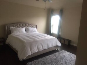 A bedroom with a large bed, a ceiling fan, and a window with curtains. - ❤️GREAT FOR FAMILIES❤️ (Lawrenceville)