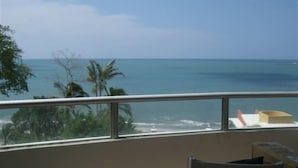 A balcony with a view of the ocean and palm trees. - Luxury Beachfront Condo with Amazing Ocean Views (Gorgona)