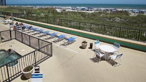A rooftop terrace with lounge chairs, a hot tub, and a view of the beach. - Sea Castle 2F-Oceanfront 3 Bedroom- Pool & Hot Tub (North Myrtle Beach)