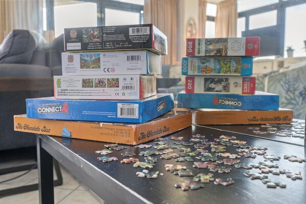 A table with several puzzle boxes stacked on top of each other.