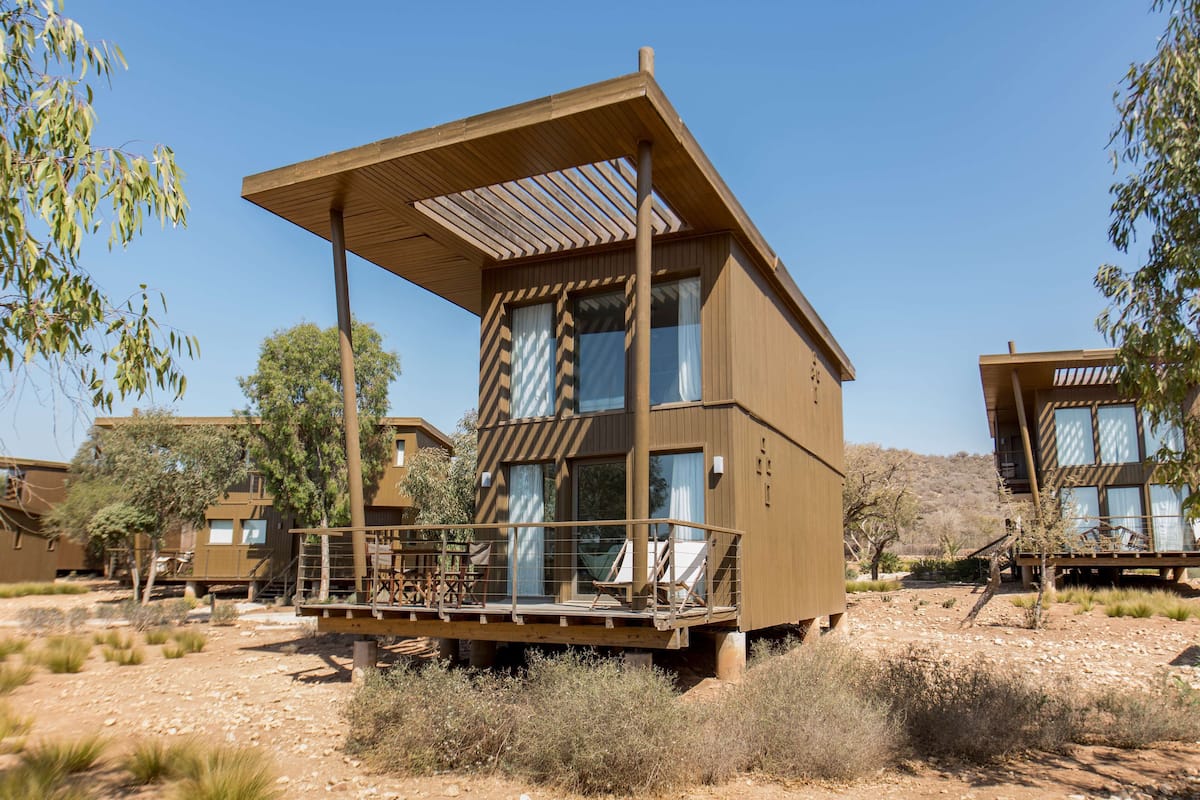 A modern, multi-story building with a wooden deck and large windows.