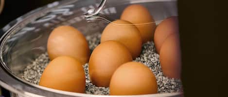 A bowl of eggs with a metal lid.