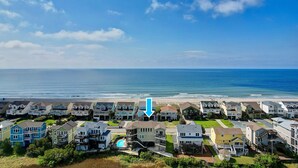 A coastal residential area with houses, a pool, and a view of the ocean. - "Cool Fish" - 2nd Row Home w/ Private Pool, 5 Bedrooms / 4.5 Bathrooms (Holden Beach)