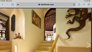 A staircase with a wooden handrail, a painting, and a decorative wall piece. - Great ocean views, walking distance to town/ beach, heated pool, family friendly (Sayulita)