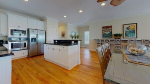 A modern kitchen with white cabinetry, stainless steel appliances, and a central island. - Paradise awaits! 7 Bedroom, Private Neighborhood Pool, Walk to the Beach! (Isle Of Palms)