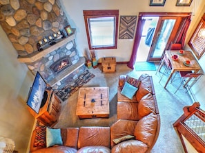Relax in this inviting living room with a fireplace, comfortable sofa, and dining area.