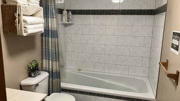 Combined shower/bathtub, towels, soap, toilet paper
