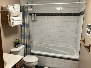 Combined shower/bathtub, towels, soap, toilet paper