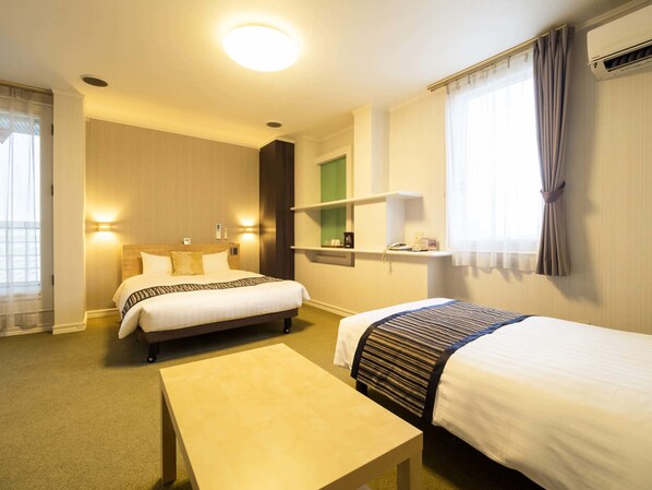 A hotel room with two beds, a small table, a shelf with toiletries, and a window with curtains. - Area One Obihiro Hotel (Obihiro)