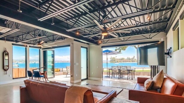 A spacious living area with a high ceiling, large windows, and a view of the sea. - Modern WaterFront House * 2 Levels * 4 Parking * AC (San Diego)