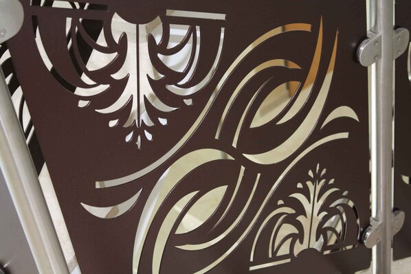 A decorative metal panel with intricate cut-out designs. - Holiday apartment with balcony and air conditioning (Lignano)