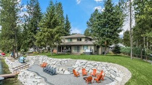 A house with a stone patio and outdoor seating area. - Luxury Family Waterfront Home | Dock + SUP/Kayak (Sagle)