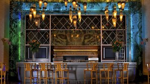 A bar area with wooden chairs, a counter with glasses, and hanging lights. - Vidanta Mayan Palace 2 BR 2 BA Suite With Kitchen Sleeps 8 - Cancun Riviera Maya (Carmen Carretera Federal)