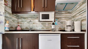 A compact kitchen with a microwave, coffee maker, and a refrigerator. - Vacation Home 'El Lagar' with Mountain View, Shared Terrace and Wi-Fi (Los Silos)