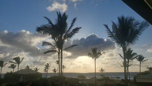 A resort with palm trees, a pool, and a view of the ocean. - KAUA'I BEACH RESORT-BEACHFRONT, OCEAN VIEW, POOLSIDE VIEW FROM YOUR LANAI (Lihue)