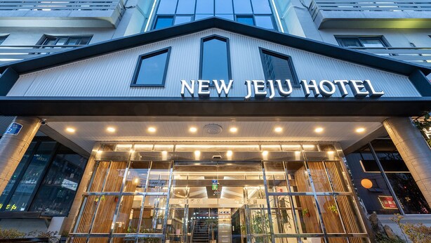 L’extérieur du nouvel hôtel Jeju présente un design moderne, de grandes fenêtres et une entrée imposante.