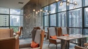 A modern interior with high-rise views, marble flooring, and contemporary furniture. - Crowne Plaza Changsha Development Zone by IHG (Changsha)