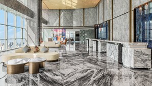 A spacious lobby with a high ceiling, marble flooring, and a seating area with sofas and round tables. - Crowne Plaza Changsha Development Zone by IHG (Changsha)