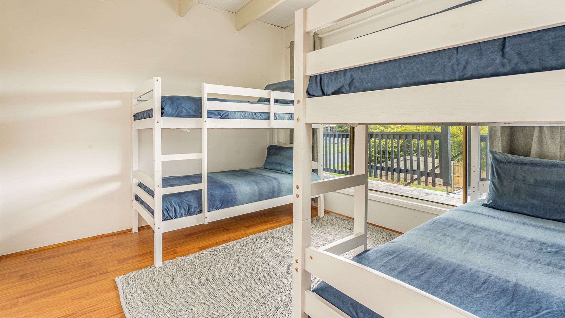 A bunk bed room with a view of the outside.