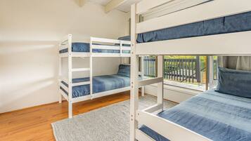 A bunk bed room with a view of the outside.