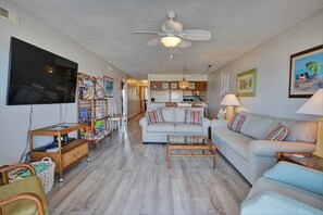 Relax in this open-plan living space with a comfortable sofa set, flat-screen TV, and dining area.