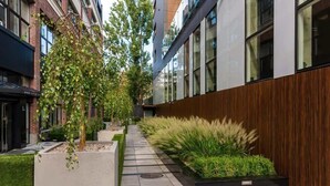 Un bâtiment moderne avec une façade en briques, de grandes fenêtres et un mur revêtu de panneaux en bois.