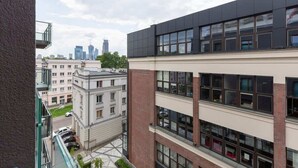 Un immeuble à plusieurs étages, doté d’une architecture moderne, avec de grandes fenêtres et une combinaison de façades en brique et en béton.