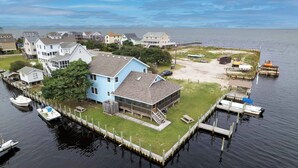 A residential area with houses, a dock, and boats.