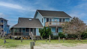A two-story building with a balcony, a deck, and a sign reading "Baker House."
