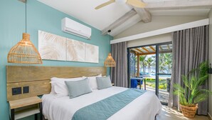 A bedroom with a large bed, wooden headboard, and a view of the outdoors.