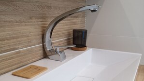 A modern bathroom with a white sink, a wooden cutting board, a soap dispenser, and a bottle of hand soap. - Chambre La Centrale : private terrace -Heated swimming pool, 5mn from the beach (Soorts-Hossegor)