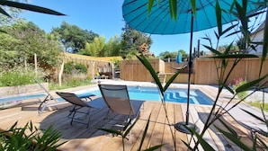A wooden deck with a pool, lounge chairs, and a hammock. - Chambre La Centrale : private terrace -Heated swimming pool, 5mn from the beach (Soorts-Hossegor)