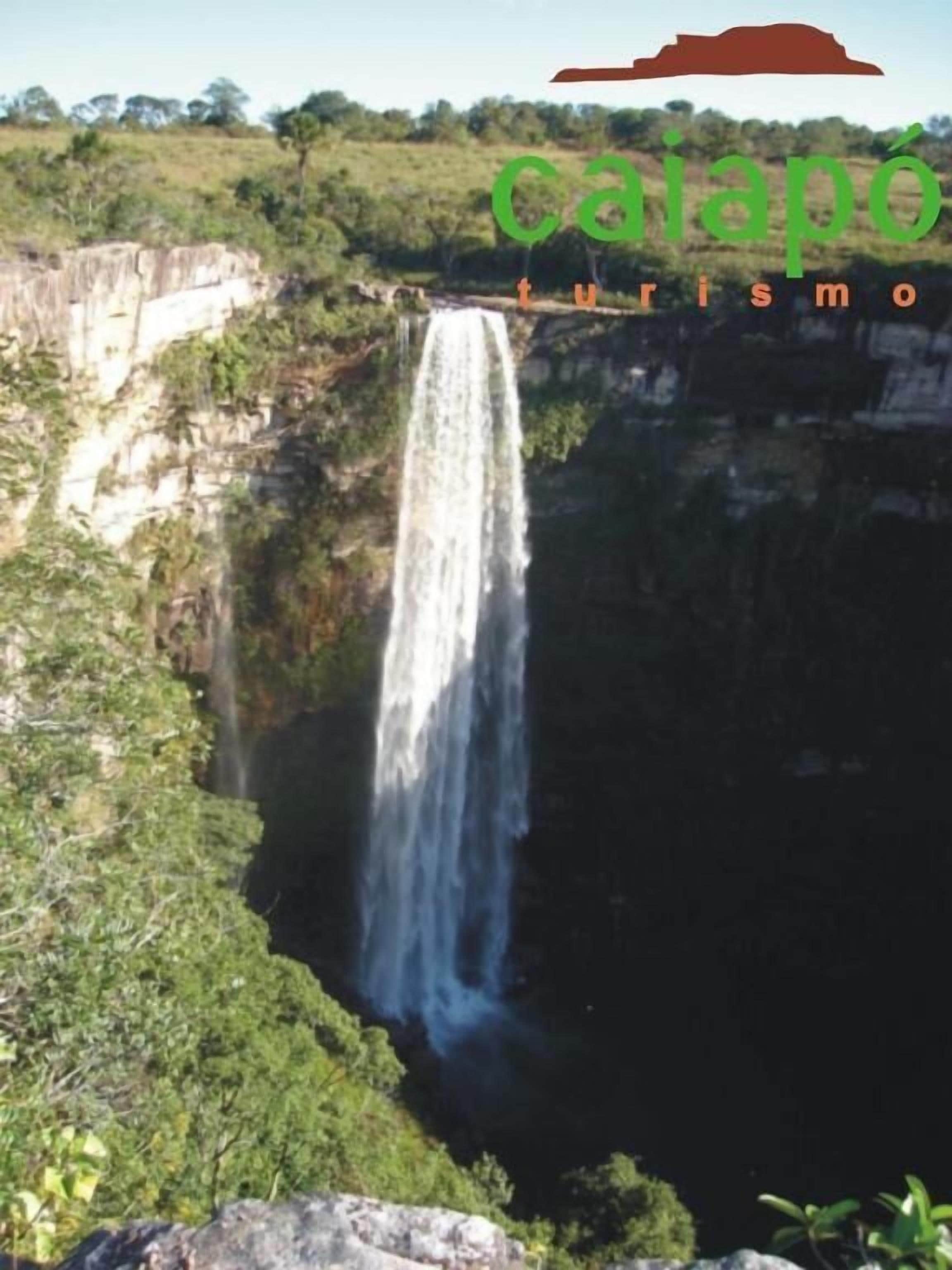 Une cascade se déversant le long d’une falaise, entourée d’une végétation luxuriante.