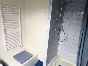 Een douche, een haardroger, zeep, toiletpapier
